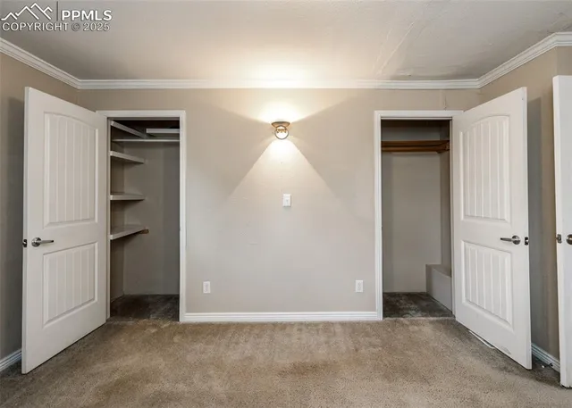 an empty room with closet and a hallway