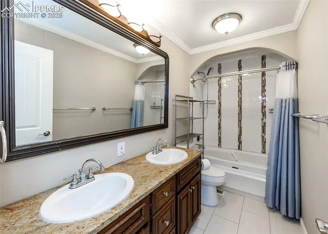 a bathroom with a granite countertop sink a toilet a mirror and shower