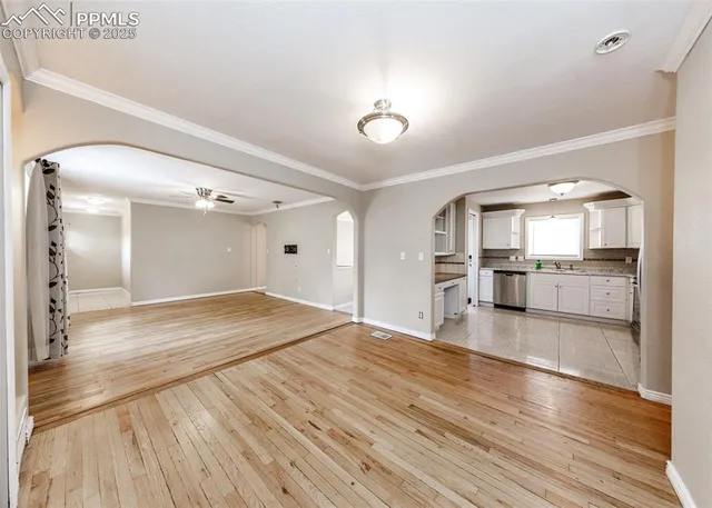 a view of a kitchen with wooden floor and a kitchen