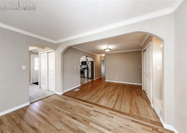 a view of a livingroom with wooden floor and staircase