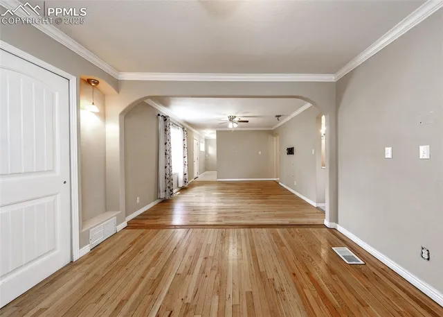 a view of a room with wooden floor and staircase