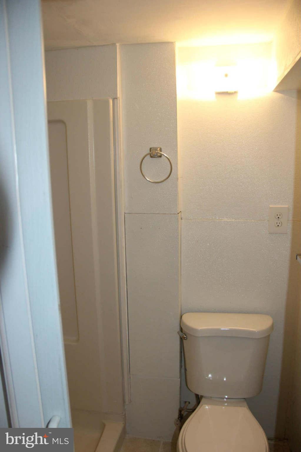 8424 Oakleigh Road Baltimore, MD 21234 - Photo 11 of 11 a white toilet sitting next to a shower