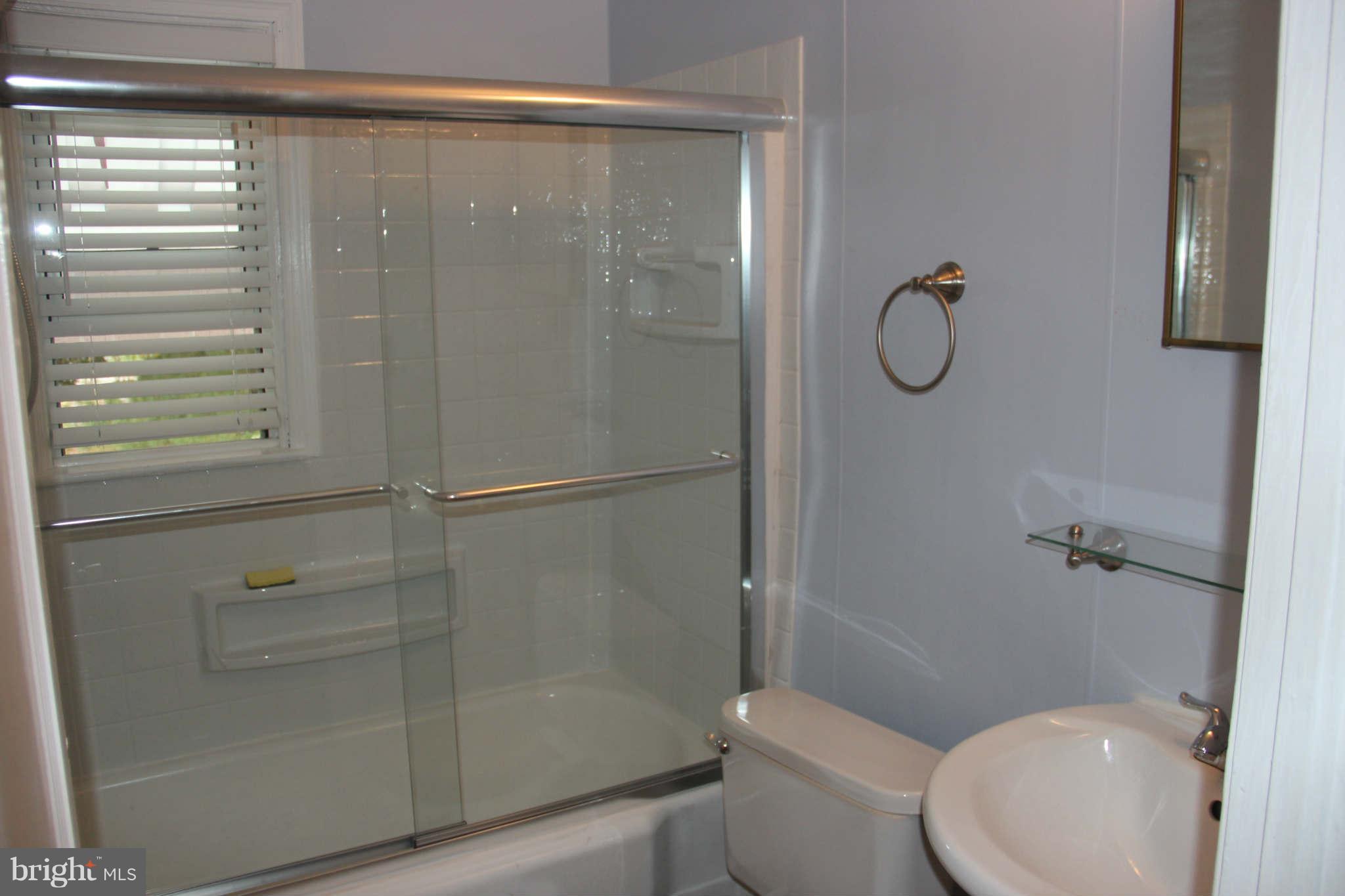 8424 Oakleigh Road Baltimore, MD 21234 - Photo 4 of 11 a bathroom with a shower a toilet and a sink
