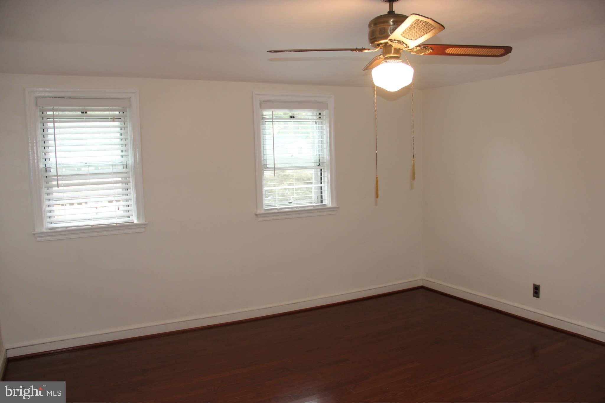 8424 Oakleigh Road Baltimore, MD 21234 - Photo 9 of 11 an empty room with windows and fan