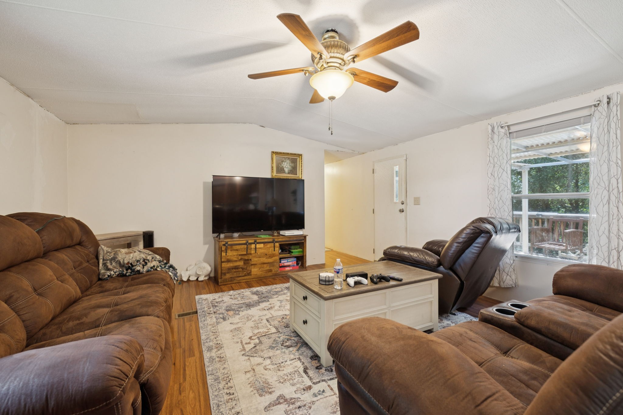 167 Green Hill Road Pleasant Shade, TN 37145 - Photo 16 of 43 a living room with furniture and a flat screen tv