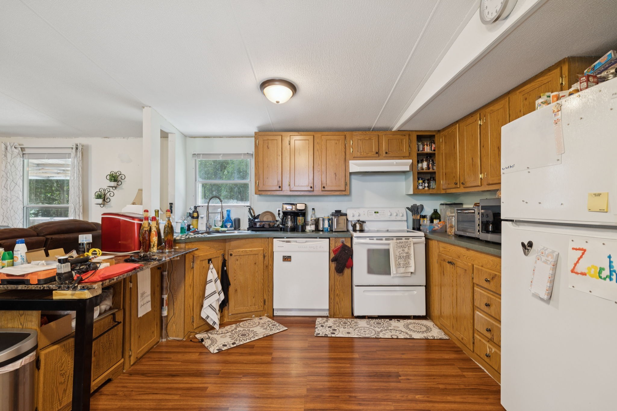 167 Green Hill Road Pleasant Shade, TN 37145 - Photo 18 of 43 a kitchen with stainless steel appliances granite countertop a stove top oven a refrigerator a sink dishwasher and white cabinets with wooden floor