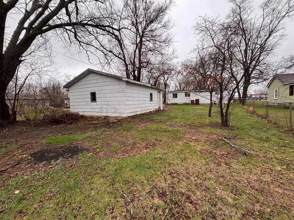 a view of a yard with a house and a tree