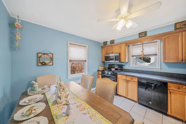 a large kitchen with stainless steel appliances granite countertop a stove a sink a dining table and chairs with wooden floor