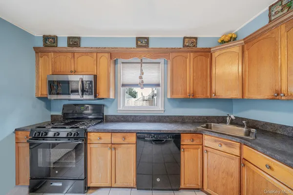 a kitchen with stainless steel appliances a stove a sink and a microwave