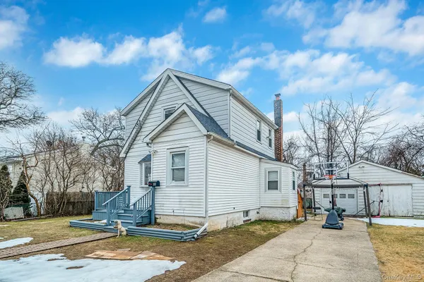 a backyard of a house with table and chairs