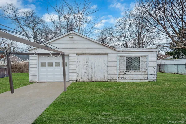 a front view of a house with a garden and yard