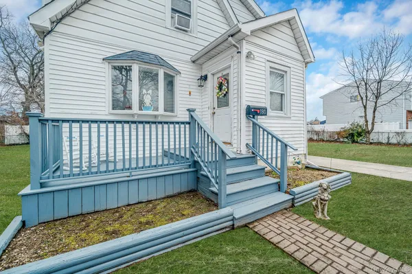 a view of a wooden deck with a yard