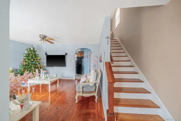 a view of entryway and hall with wooden floor