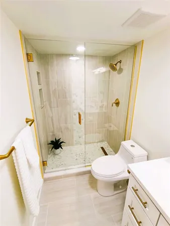 a bathroom with a sink toilet and shower