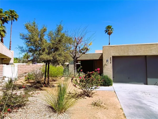 a view of a house with a yard and tree s