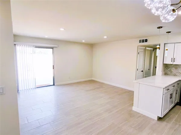 an entryway and a room with wooden floor