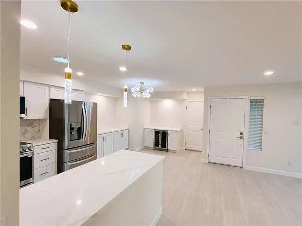 a large kitchen with a large counter top appliances and cabinets
