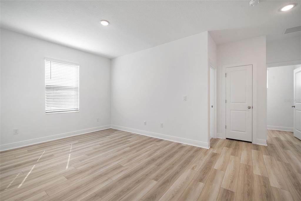 10705 Wading River Avenue Parrish, FL 34219 - Photo 15 of 28 wooden floor in an empty room with a window