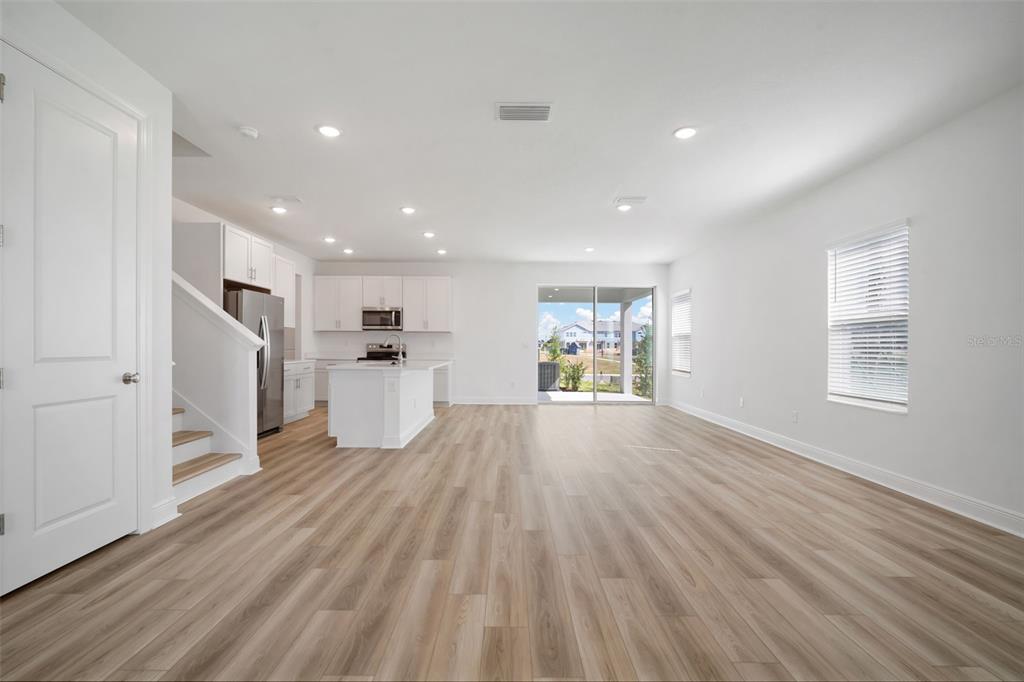 10705 Wading River Avenue Parrish, FL 34219 - Photo 5 of 28 a view of a kitchen with wooden floor and windows
