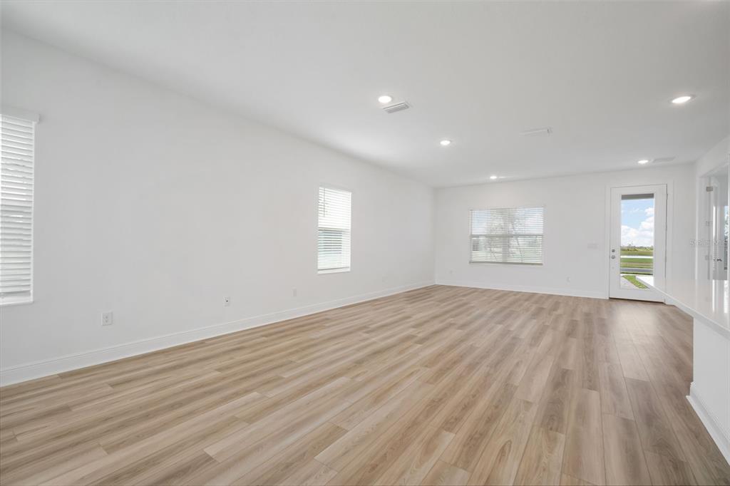 10705 Wading River Avenue Parrish, FL 34219 - Photo 8 of 28 wooden floor in an empty room with a window