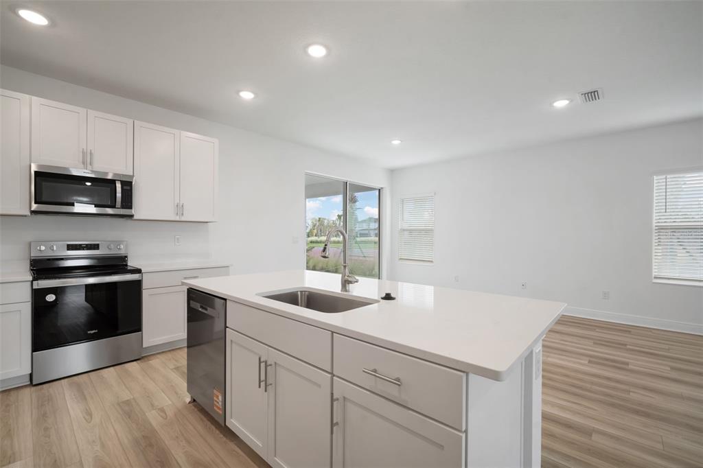 10705 Wading River Avenue Parrish, FL 34219 - Photo 10 of 28 a kitchen with a sink stove and microwave