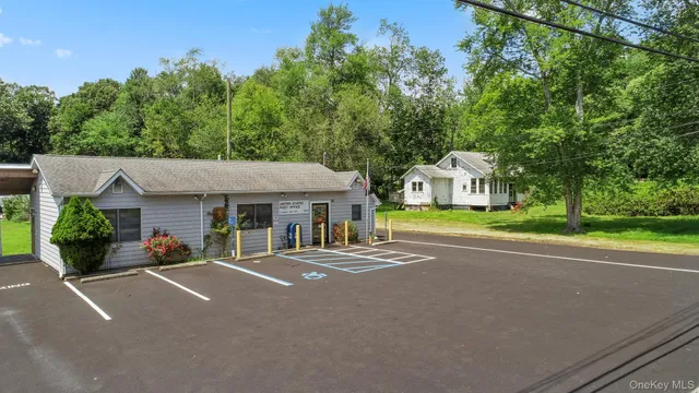 a front view of a house with a yard and potted plants