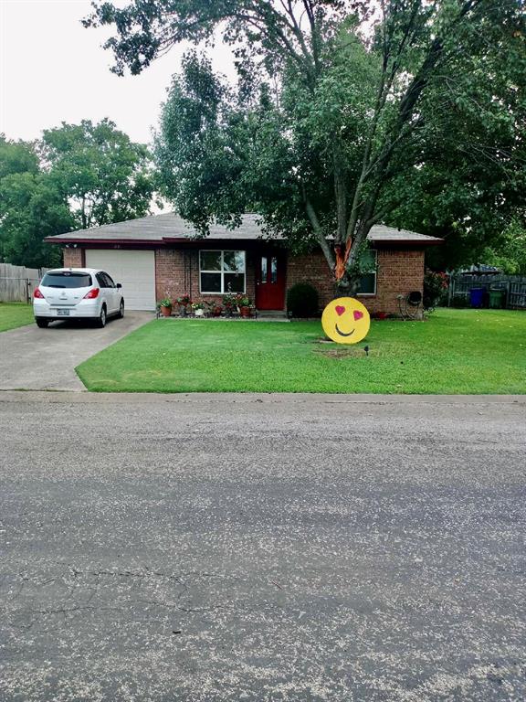 a front view of a house with a garden and fountain