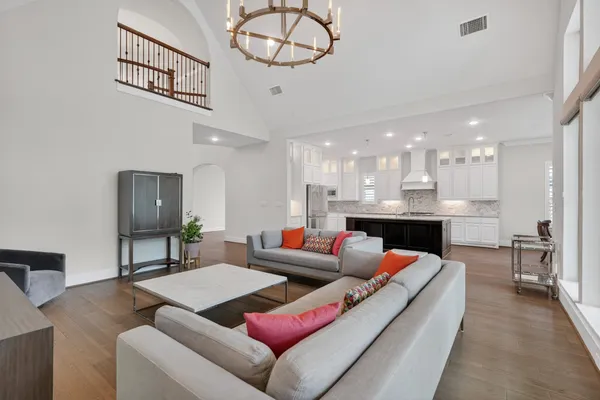 a kitchen with a stove and a view of living room