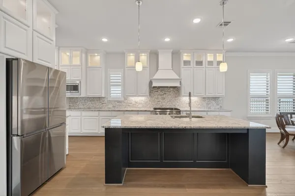 a dining room with furniture and a floor to ceiling window