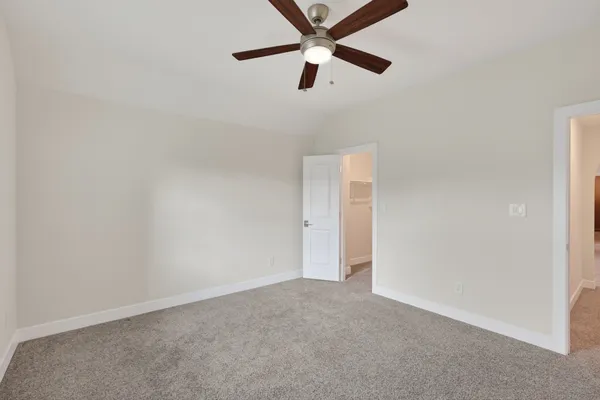an empty room with closet and windows