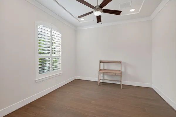 a living room with furniture and a dining table with wooden floor