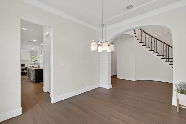 a large kitchen with stainless steel appliances granite countertop a large counter top a stove a sink and a refrigerator