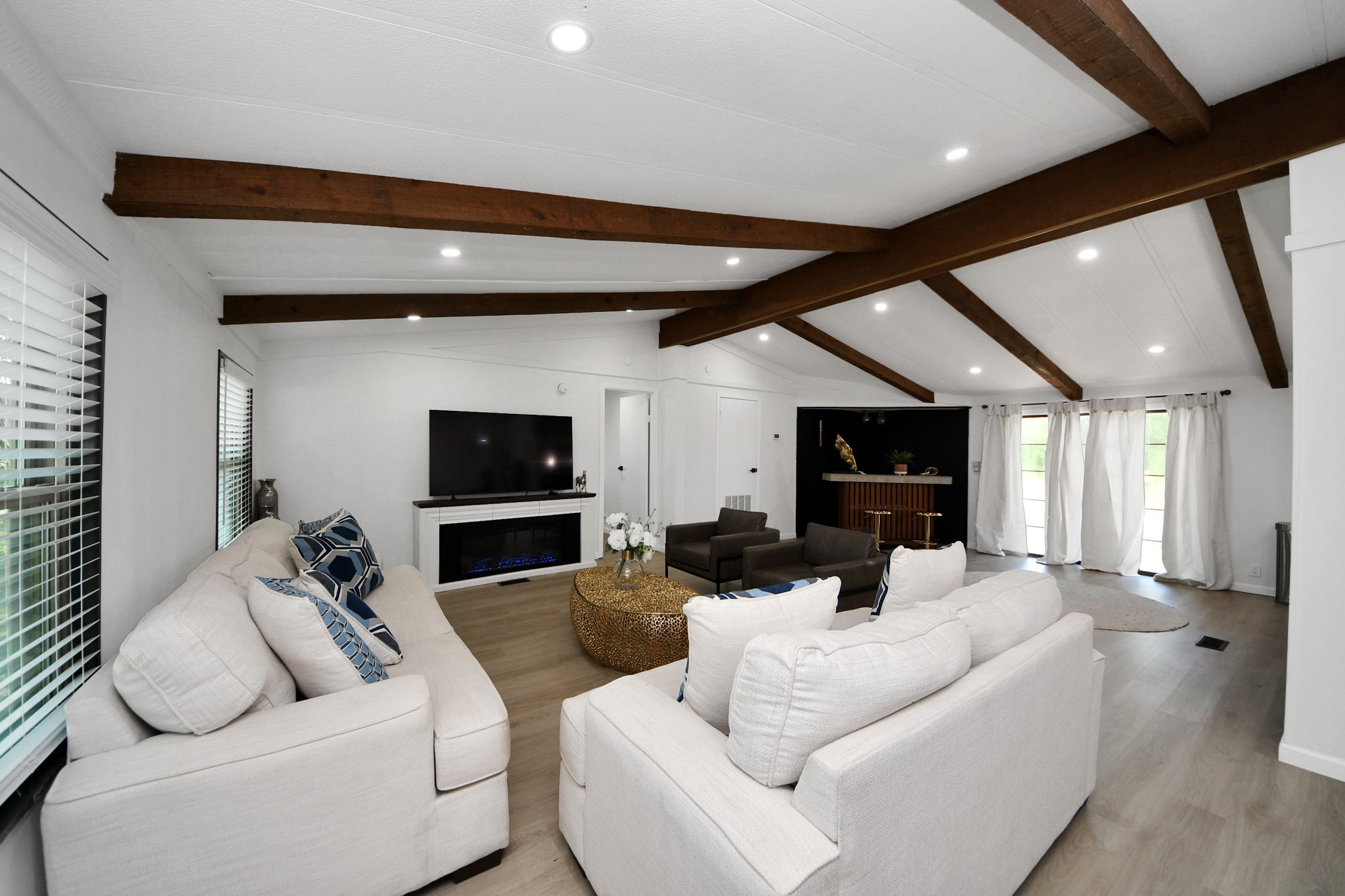 28222 Margerstadt Road Waller, TX 77484 - Photo 7 of 50 Spacious living room features soaring ceilings and exposed beam accents.