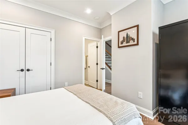a bedroom with a bed lamp and a window