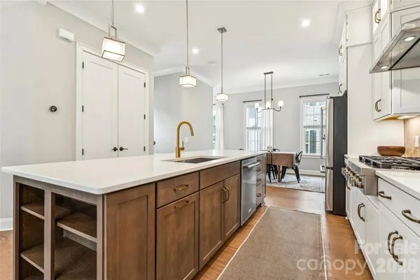 a white stove top oven sitting inside of a kitchen