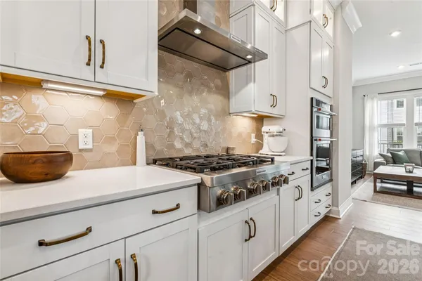 a kitchen with stainless steel appliances granite countertop a stove and a microwave