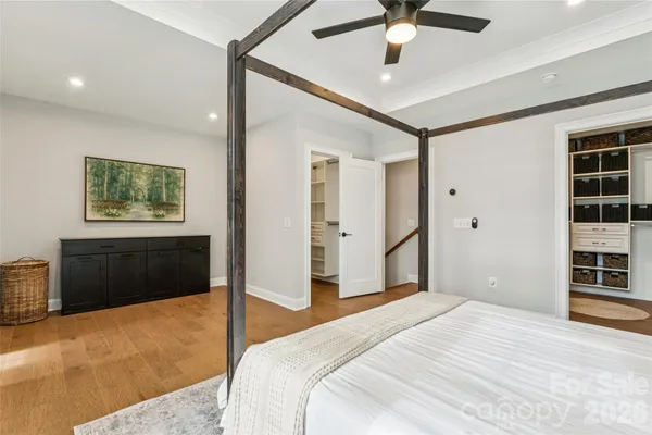 a bedroom with a large bed and a chandelier