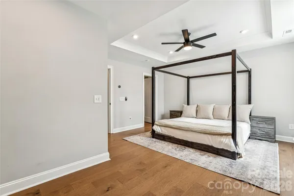 a bathroom with double vanity sink a two mirror a window a vanity and painting on the wall