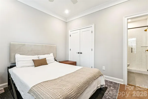 a bedroom with a bed and a painting on the wall