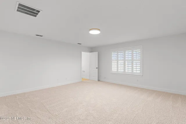 an empty room with a empty space and windows