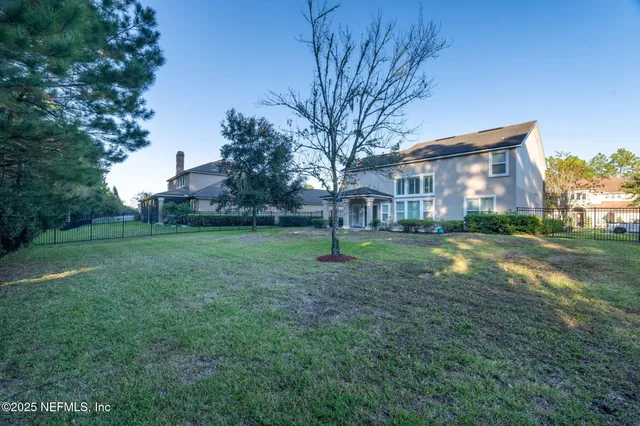 a view of a house with yard and a tree