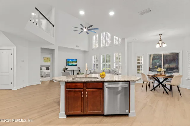 a room with stainless steel appliances lots of counter space and wooden floor