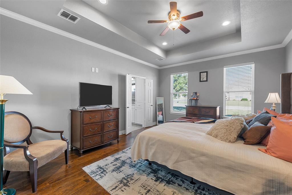 1420 Hoosier Park Robinson, TX 76706 - Photo 13 of 40 Primary Bedroom with a raised ceiling, hardwood flooring, crown molding, recessed lighting, and a ceiling fan