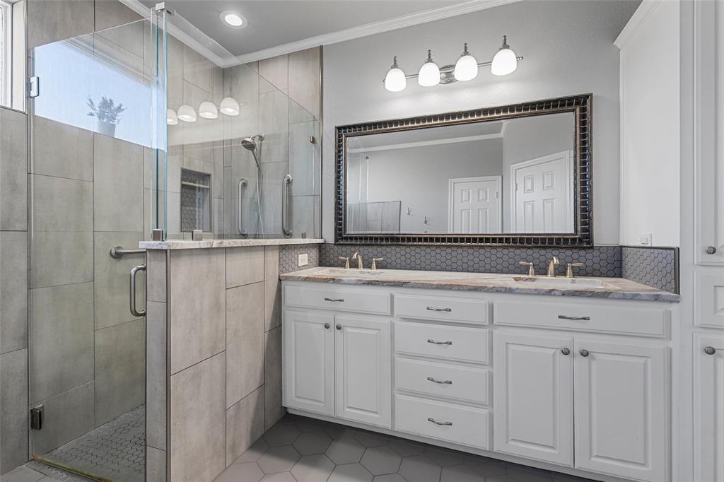 1420 Hoosier Park Robinson, TX 76706 - Photo 14 of 40 Primary Bathroom featuring a custom walk-in tiled shower , double vanity, crown molding, decorative backsplash, and tile patterned flooring
