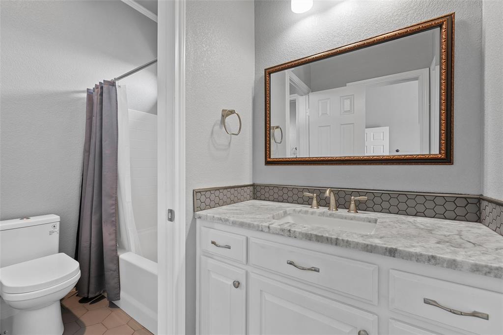 1420 Hoosier Park Robinson, TX 76706 - Photo 18 of 40 Bathroom with shower / bathtub combination , vanity and light tile patterned flooring