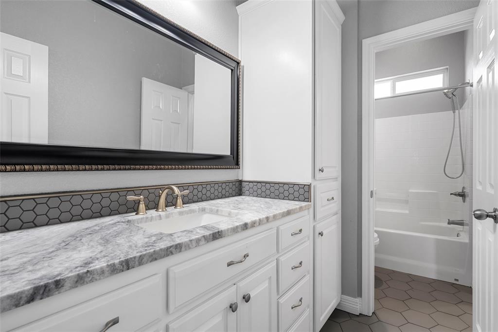 1420 Hoosier Park Robinson, TX 76706 - Photo 19 of 40 Full bath with vanity, tub / shower combination, and light tile patterned flooring