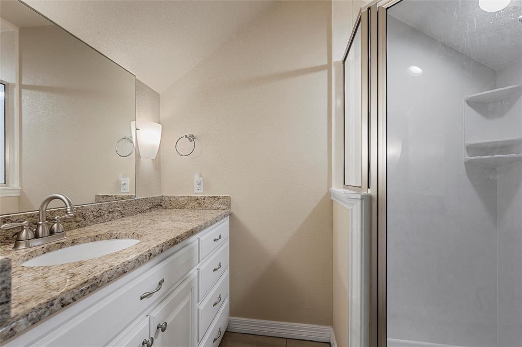 1420 Hoosier Park Robinson, TX 76706 - Photo 27 of 40 Upstairs Full Bathroom featuring vanity, a stall shower, lofted ceiling, and light tile patterned flooring