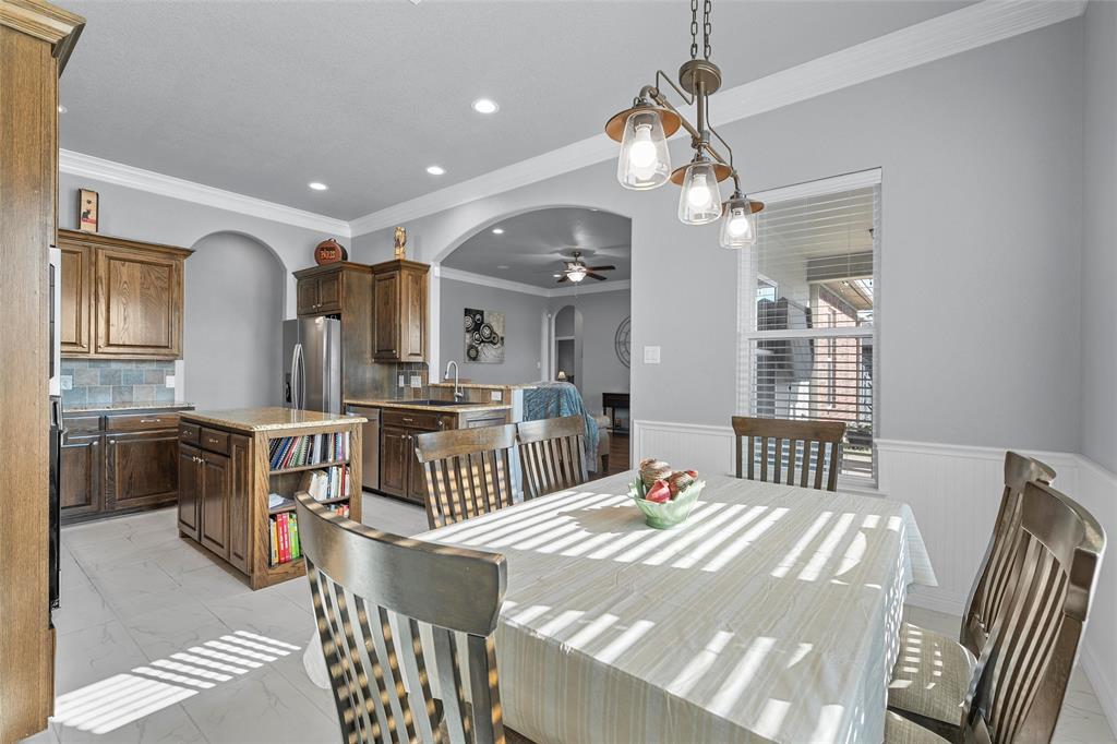 1420 Hoosier Park Robinson, TX 76706 - Photo 7 of 40 Dining space featuring arched walkways, ornamental molding, recessed lighting, light marble finish flooring, and ceiling fan