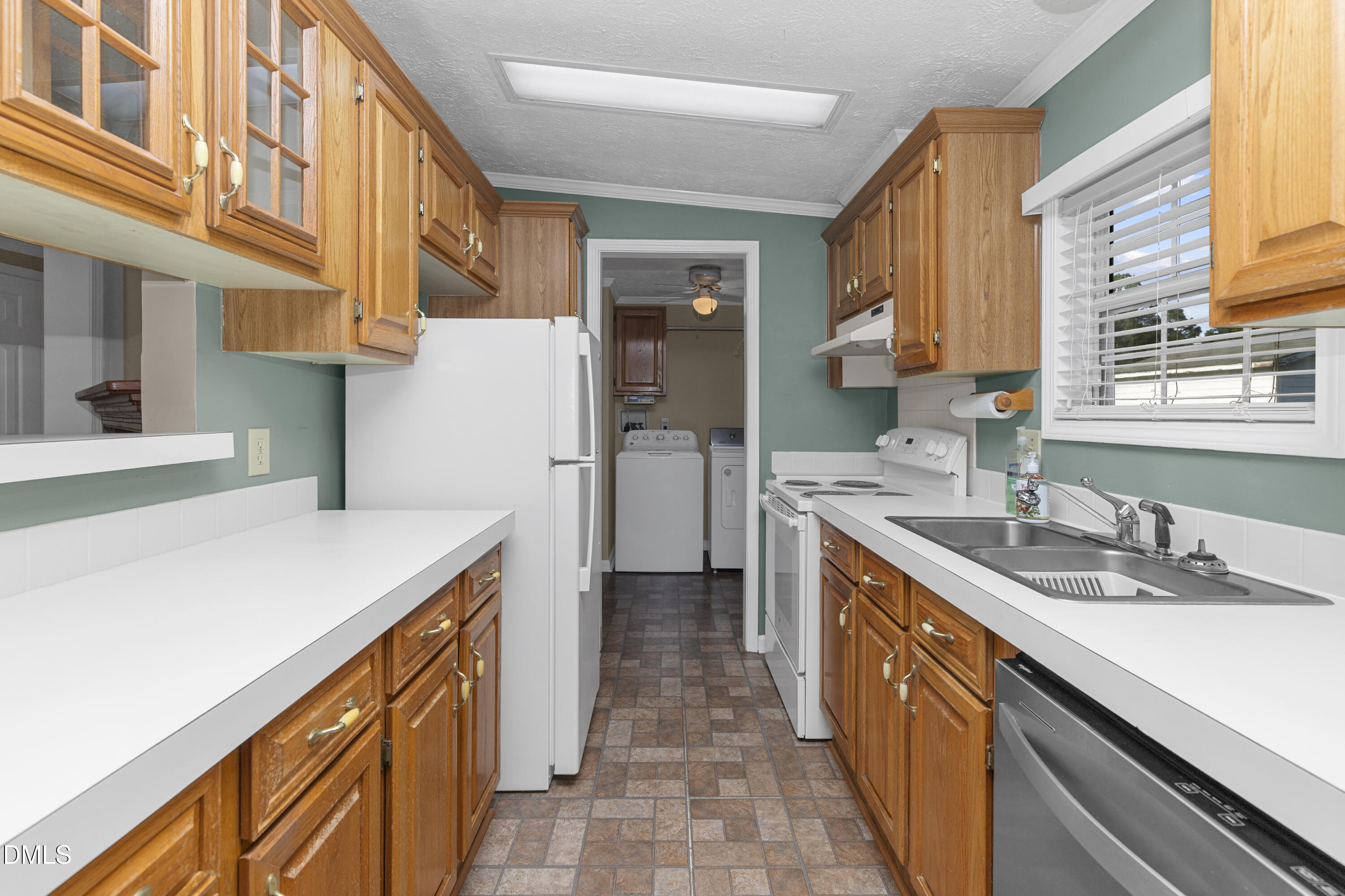 199 Iris Bryant Road Erwin, NC 28339 - Photo 8 of 33 a kitchen with a sink and a refrigerator