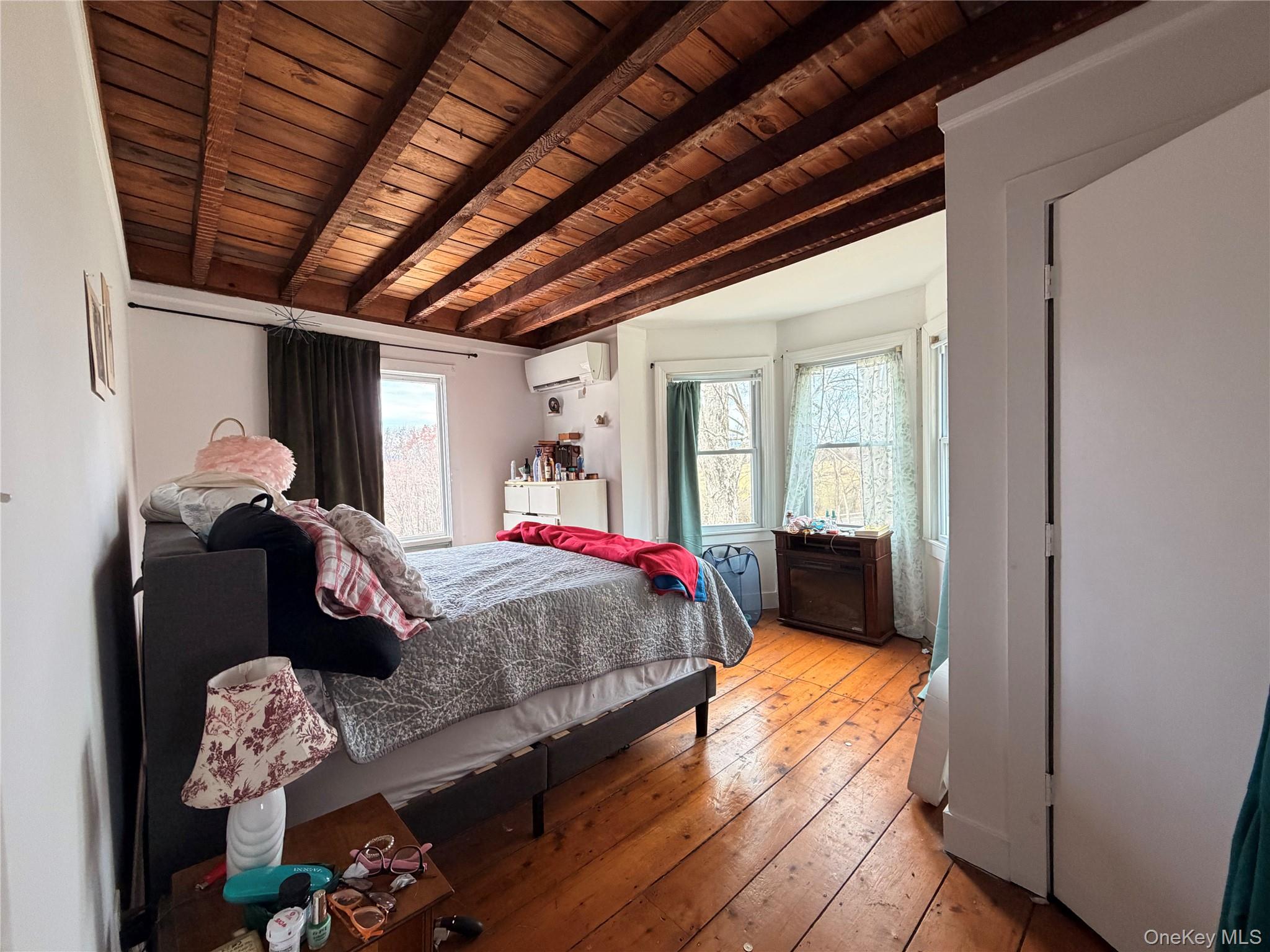 67 Old Albany Post Road, Unit 4 Rhinebeck, NY 12572 - Photo 3 of 7 a bed room with a bed and a mirror